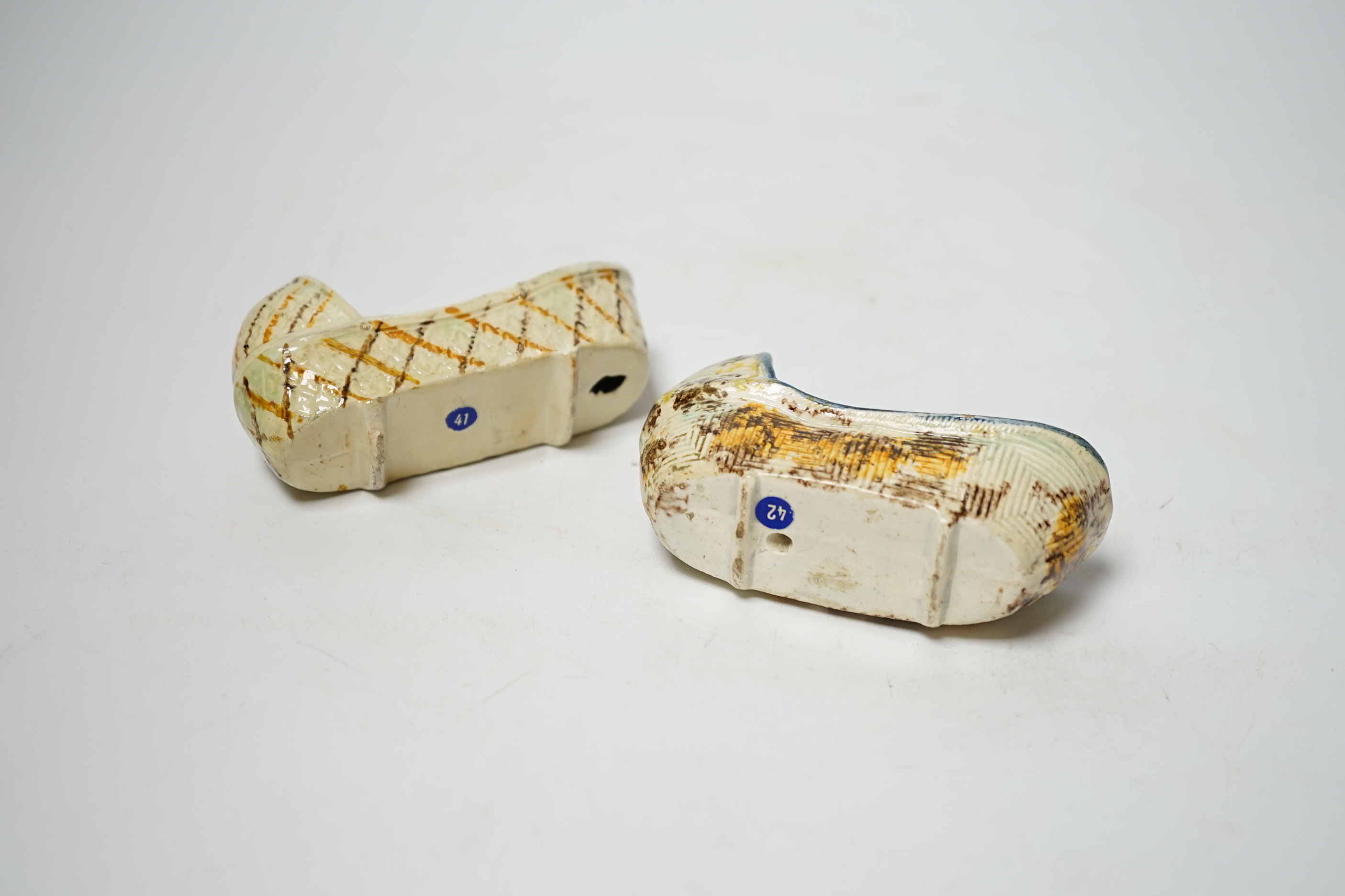 Two late 18th century Prattware ‘crib’ models of cradles, 10cm long